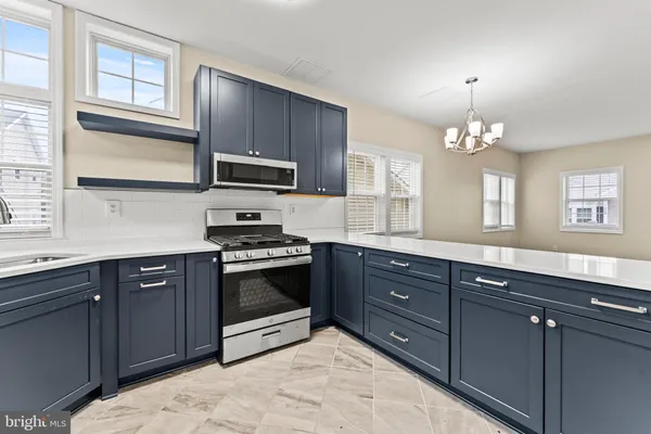 a kitchen with stainless steel appliances granite countertop a stove and a sink