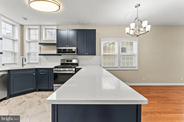 a kitchen with a stove a sink and a refrigerator