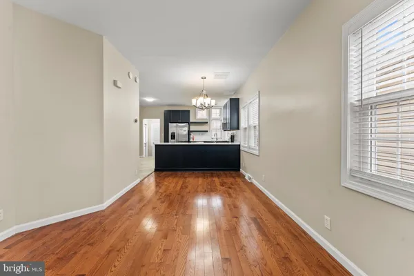 a view of kitchen and hall with wooden floor