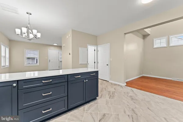 a view of kitchen with granite countertop cabinets and wooden floor