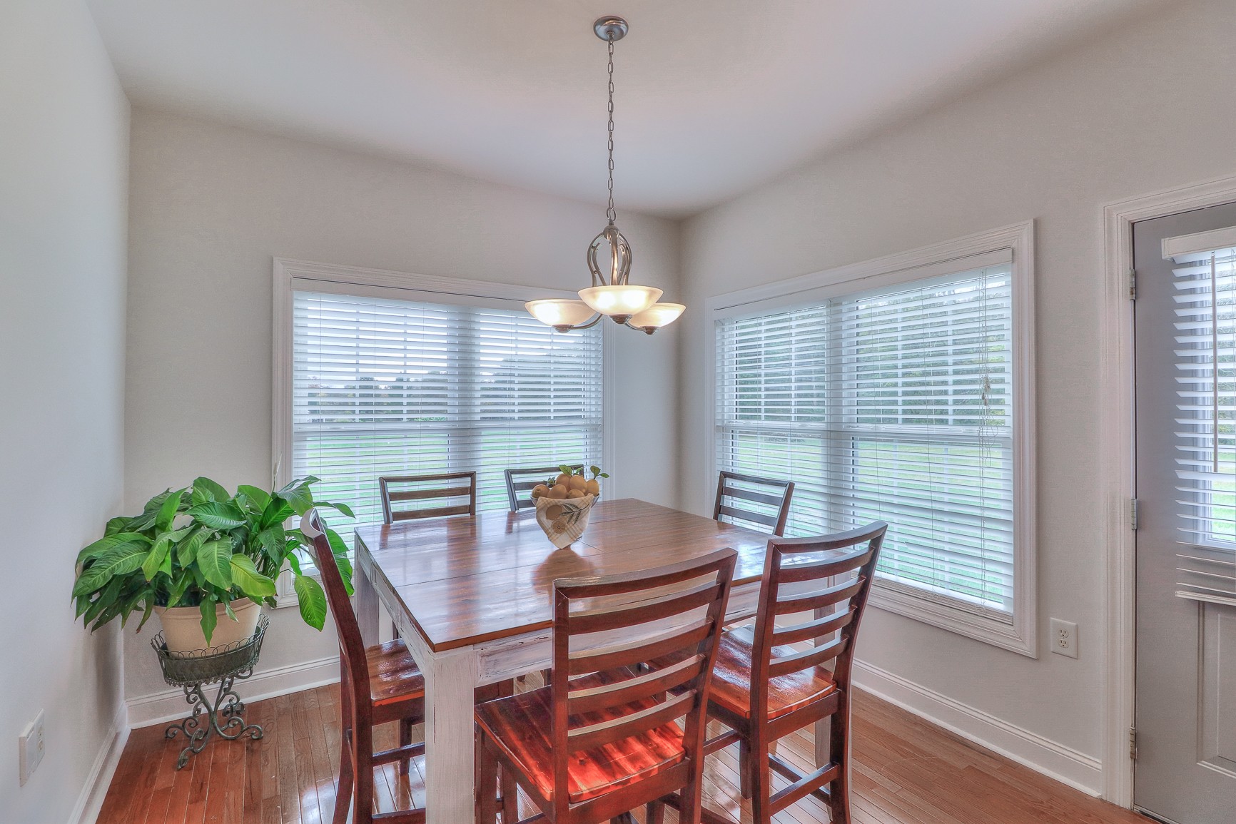 5009 Ash Hill Road Spring Hill, TN 37174 - Photo 20 of 56 a dining room with furniture potted plants and wooden floor