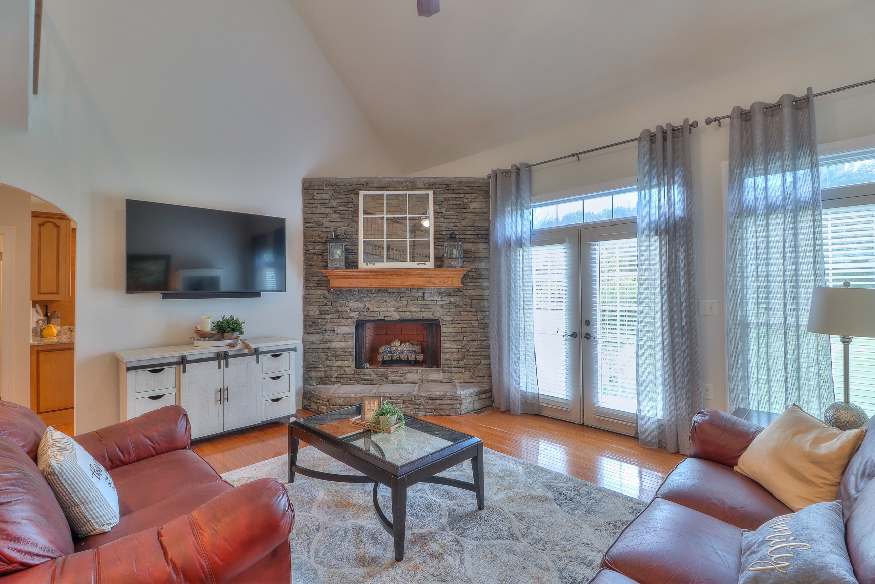 5009 Ash Hill Road Spring Hill, TN 37174 - Photo 8 of 56 a living room with furniture a flat screen tv and a fireplace