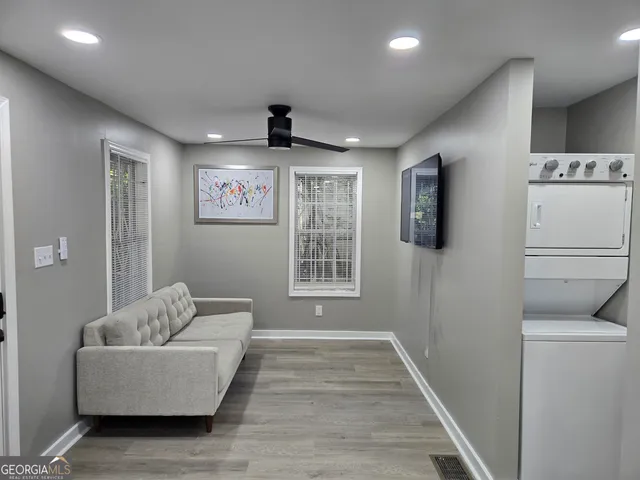 a bathroom with a granite countertop bathtub shower sink vanity and toilet