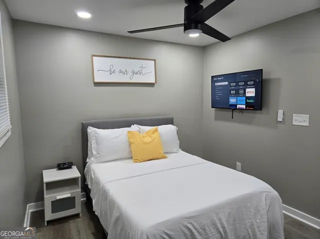 a bedroom with a bed and a window