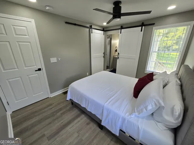 a bedroom with a bed and a painting on the wall