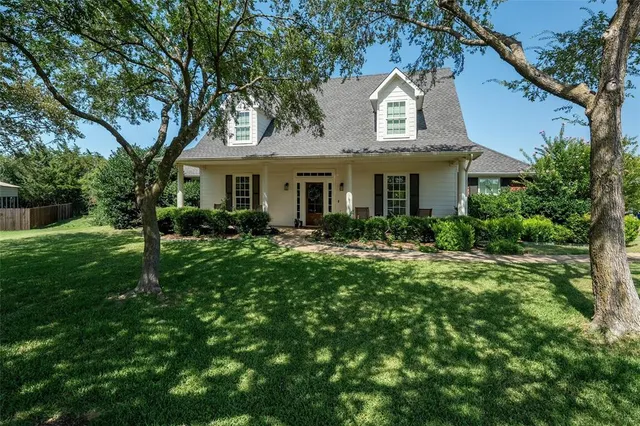 a front view of a house with yard and green space