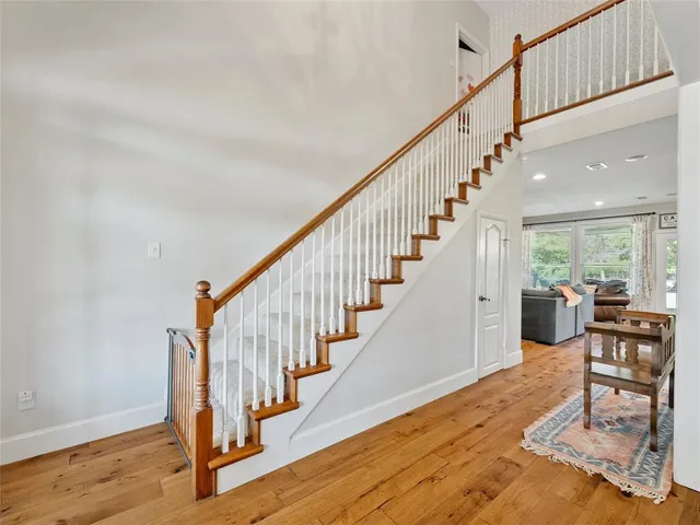 a view of entryway and hall with wooden floor