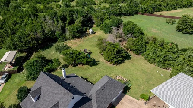 an aerial view of a house with a yard