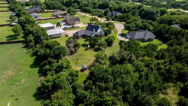 an aerial view of a house with swimming pool and outdoor space