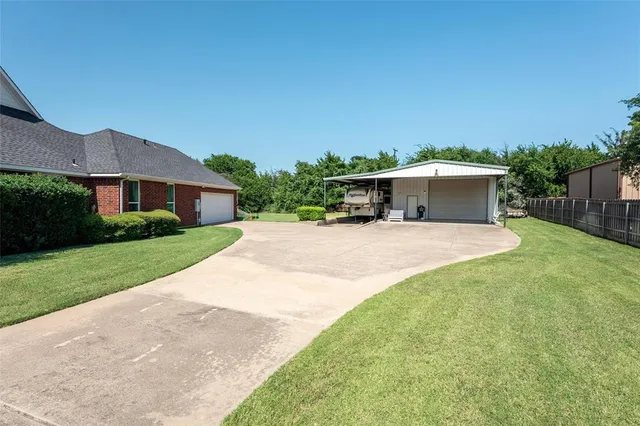 a view of house with yard outdoor seating and barbeque in the background