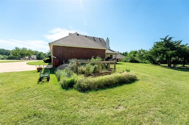 a backyard of a house with table and chairs