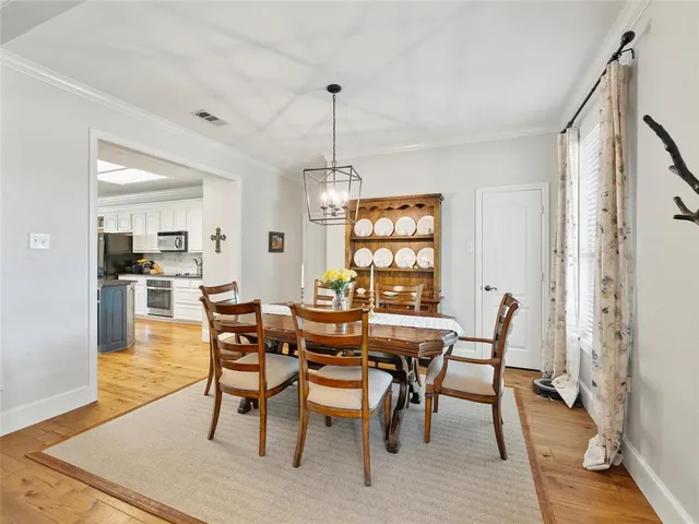 a dining room with furniture window and wooden floor