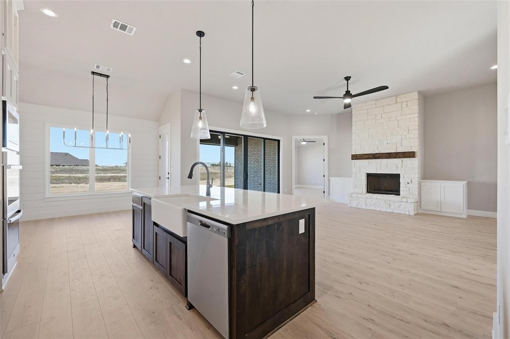 108 Rocky Top Azle, TX 76020 - Photo 4 of 40 a kitchen with stainless steel appliances granite countertop a sink a stove and a wooden floor