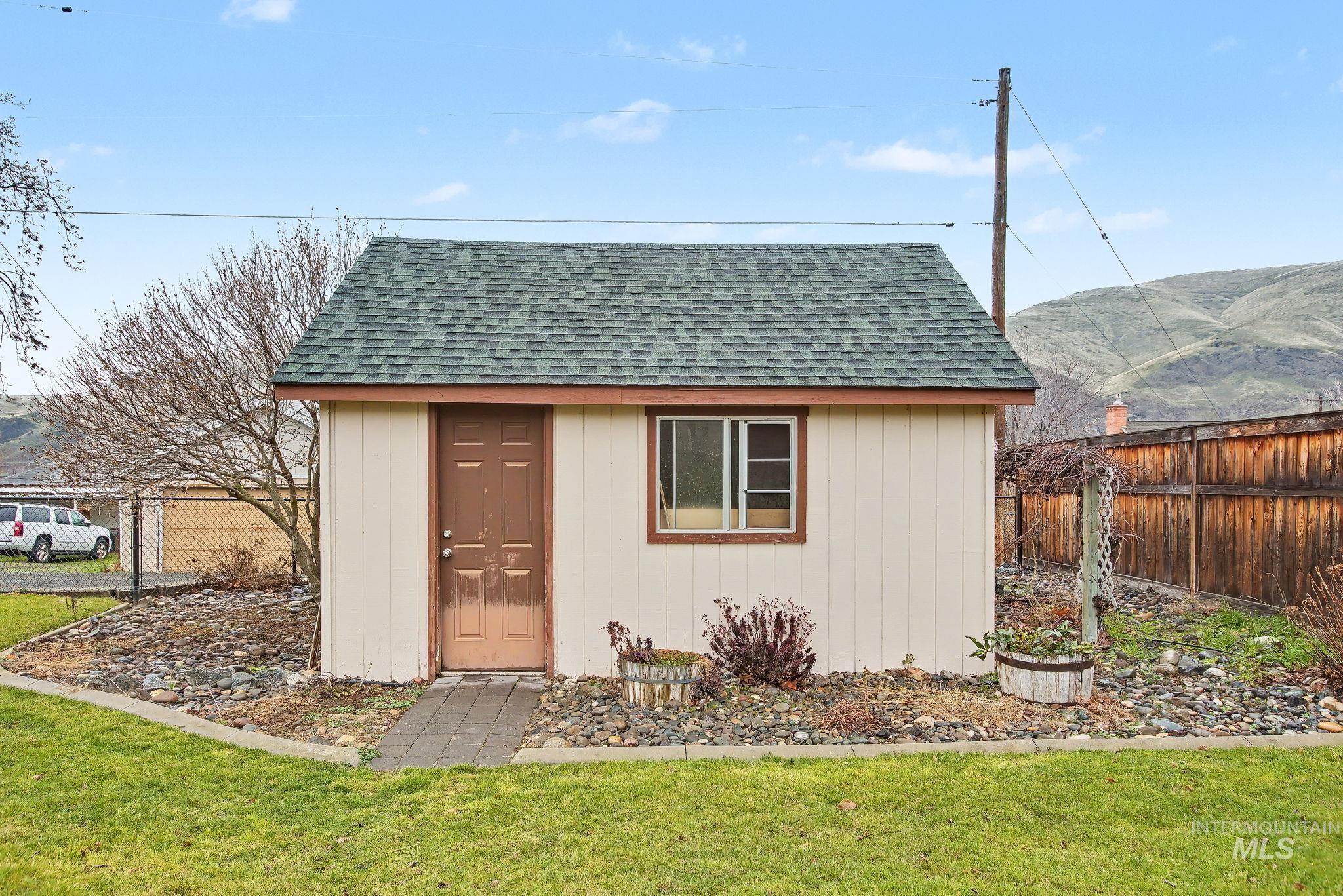 1103 3rd Street Asotin, WA 99402 - Photo 35 of 44 View of shed with a fenced backyard and a mountain view