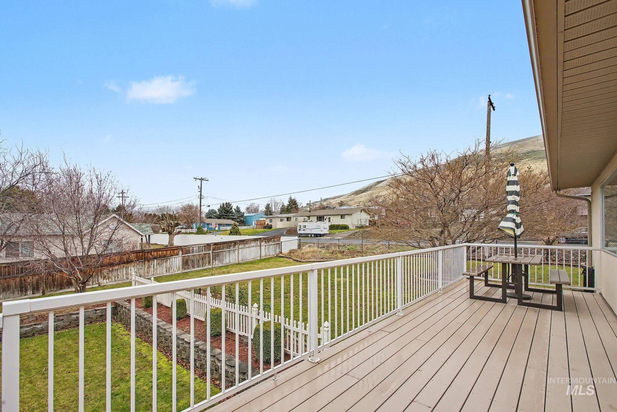 1103 3rd Street Asotin, WA 99402 - Photo 39 of 44 Wooden terrace featuring a fenced backyard and a residential view