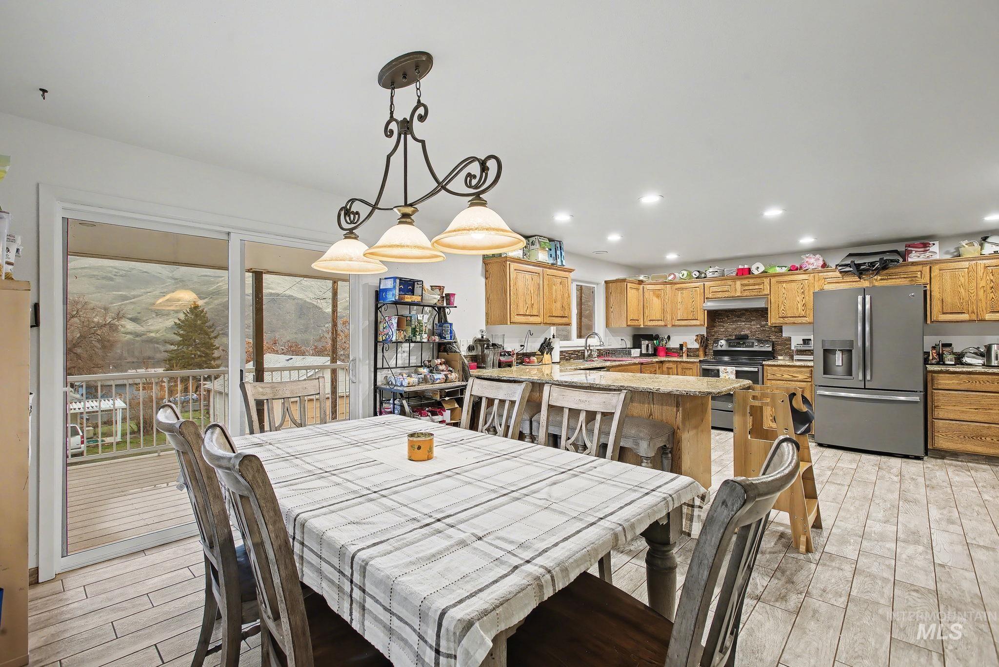 1103 3rd Street Asotin, WA 99402 - Photo 5 of 44 Dining area with wood tiled floors and access to deck