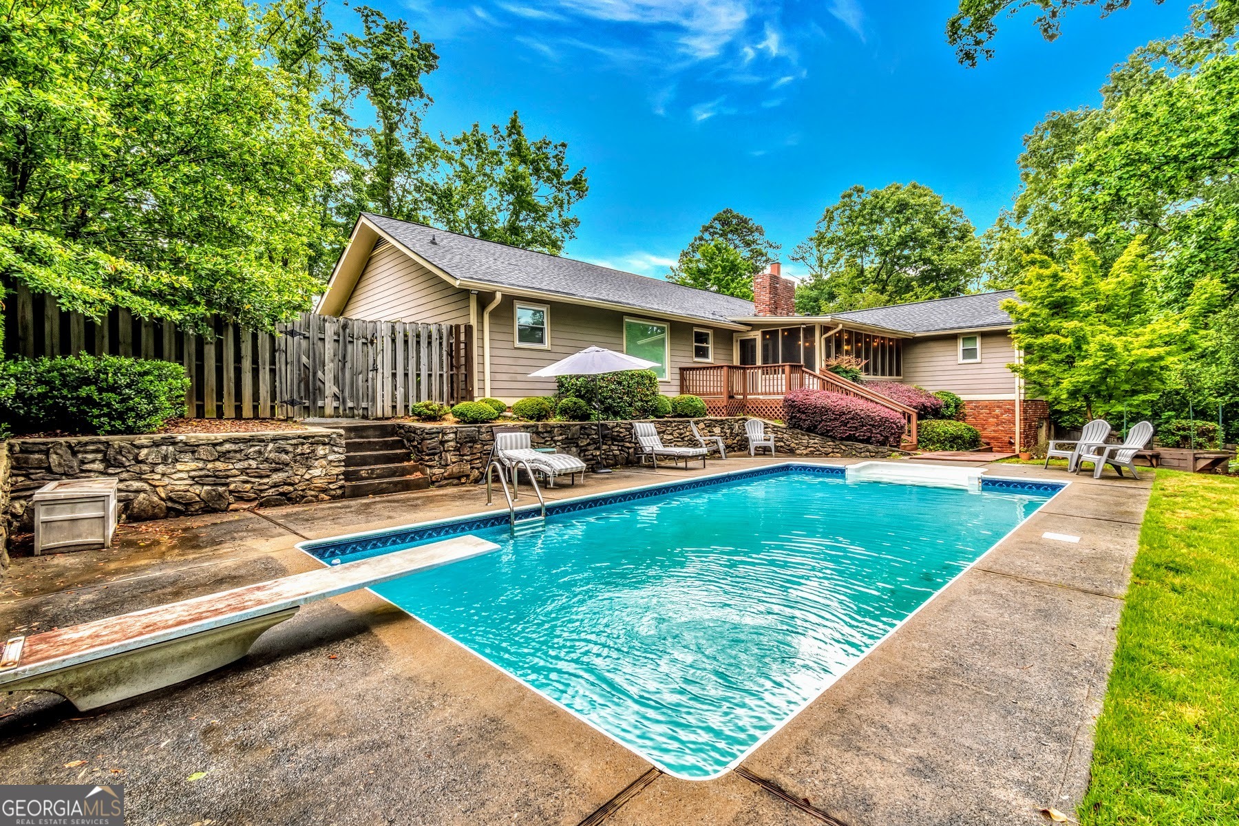 a view of a house with swimming pool and sitting area