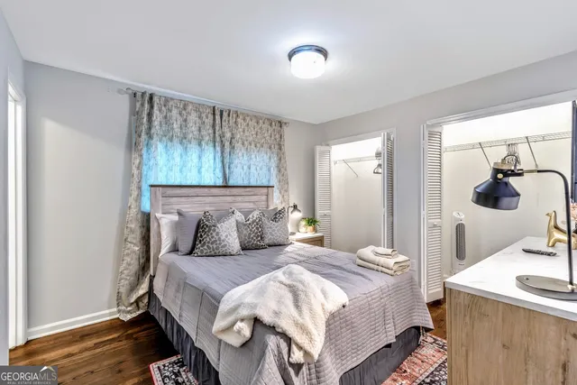 a bedroom with a bed and wooden floor