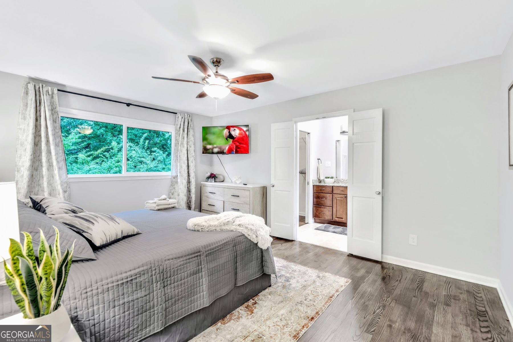 1897 Mt Vernon Road Dunwoody, GA 30338 - Photo 22 of 40 a bedroom with a bed furniture and a large window