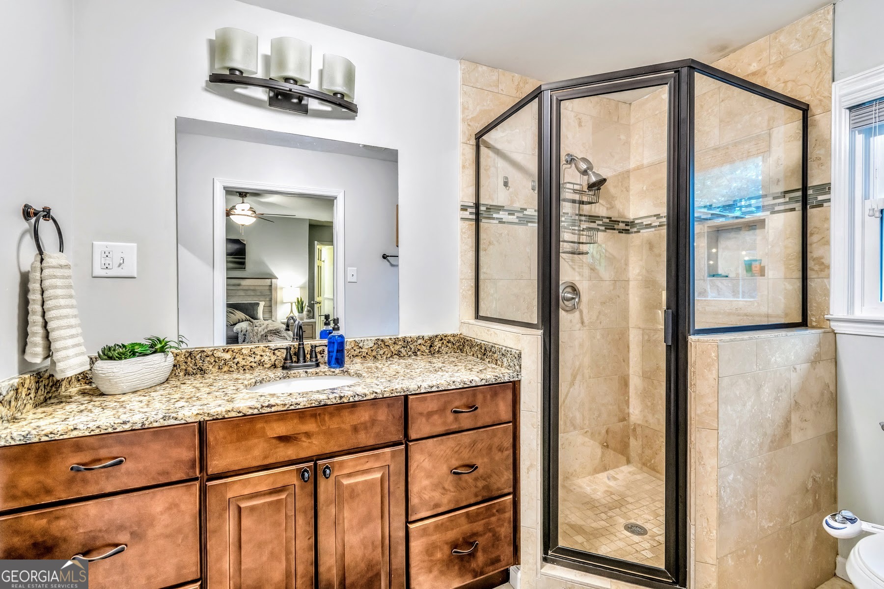 1897 Mt Vernon Road Dunwoody, GA 30338 - Photo 25 of 40 a bathroom with a granite countertop sink and a mirror