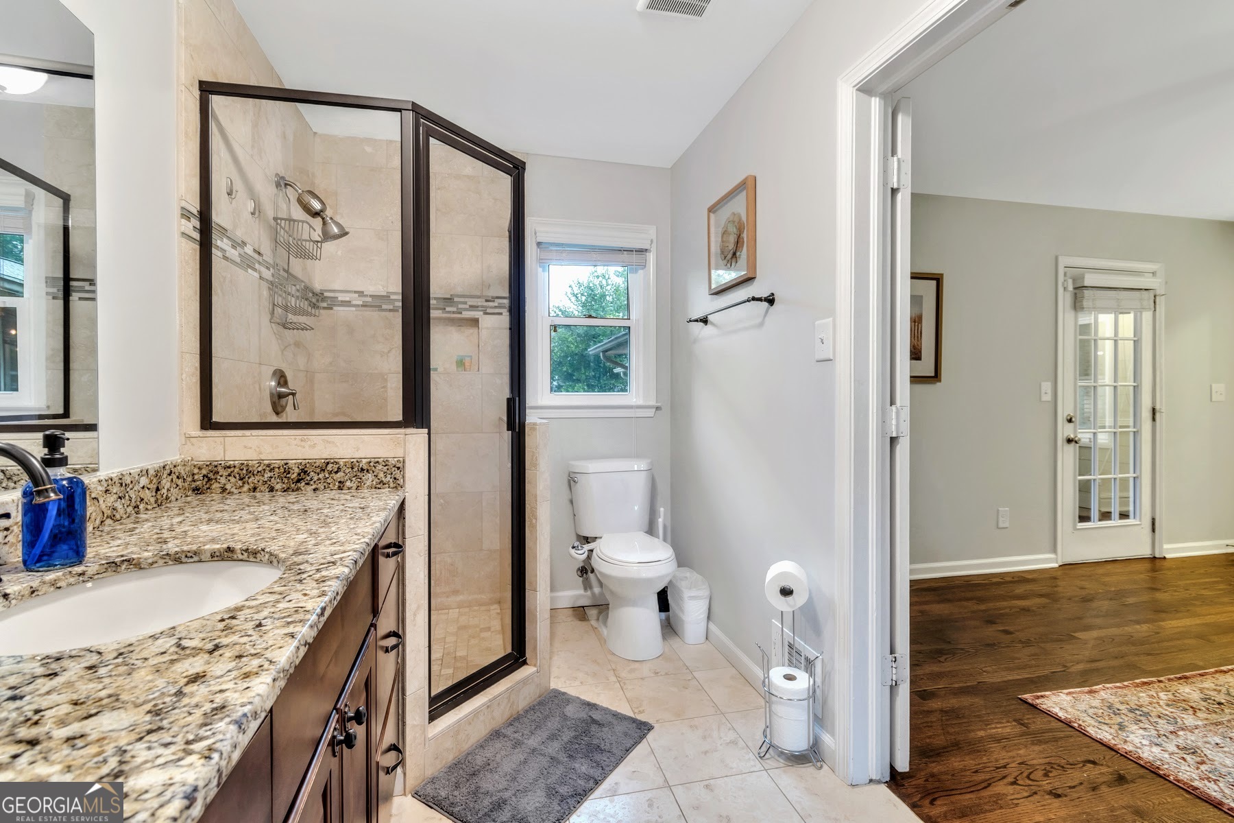 1897 Mt Vernon Road Dunwoody, GA 30338 - Photo 27 of 40 a bathroom with a granite countertop sink toilet and shower