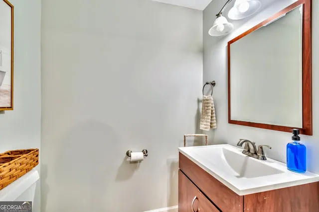 a bathroom with a sink vanity and a mirror