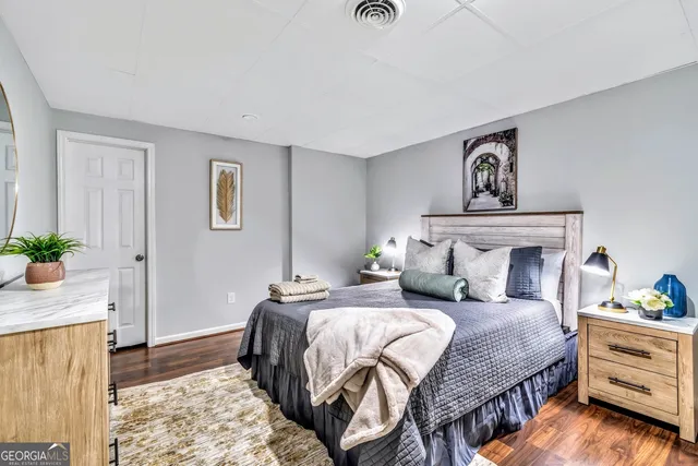 a bedroom with a bed and a potted plant