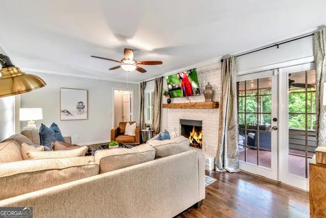 a living room with furniture a fireplace and a flat screen tv