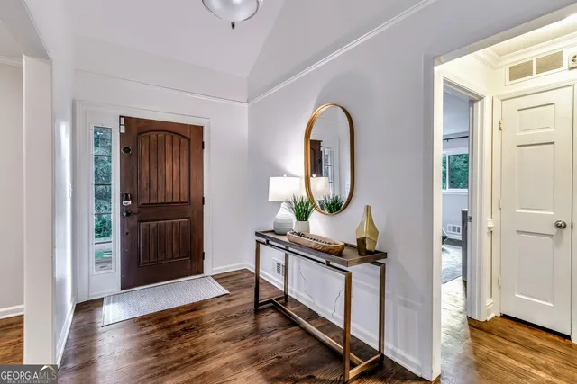 a view of kitchen with kitchen island wooden floor and refrigerator