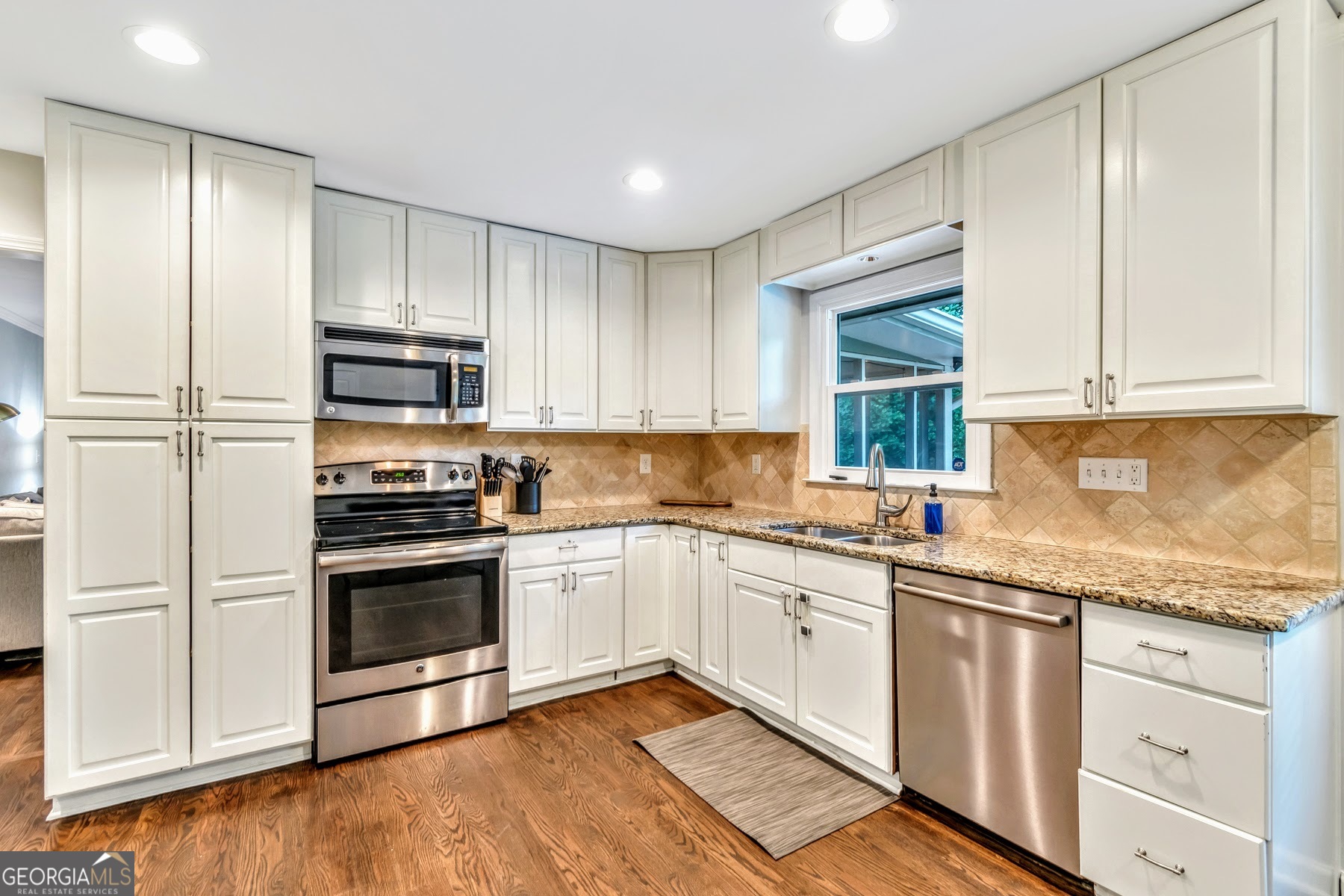 1897 Mt Vernon Road Dunwoody, GA 30338 - Photo 10 of 40 a kitchen with stainless steel appliances granite countertop a stove a sink and a refrigerator