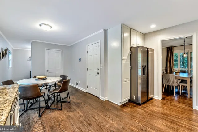 a view of a dining room with furniture and wooden floor