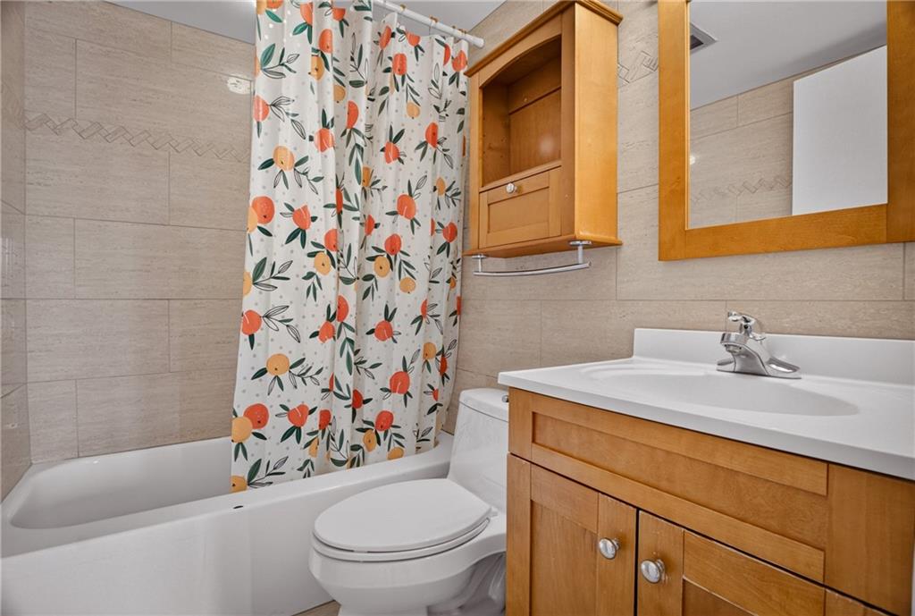 5 Bayard Road, Unit 418 Pittsburgh, PA 15213 - Photo 27 of 45 This charming bathroom combines classic touches with cozy elegance, featuring a rich wood vanity and framed mirror that offer both warmth and functionality.