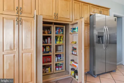 a kitchen with stainless steel appliances a refrigerator and cabinets
