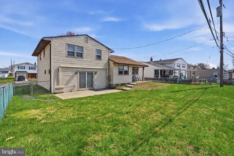 a view of a house with a yard and sitting area