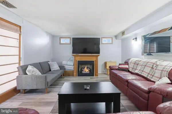 a living room with furniture and a piano