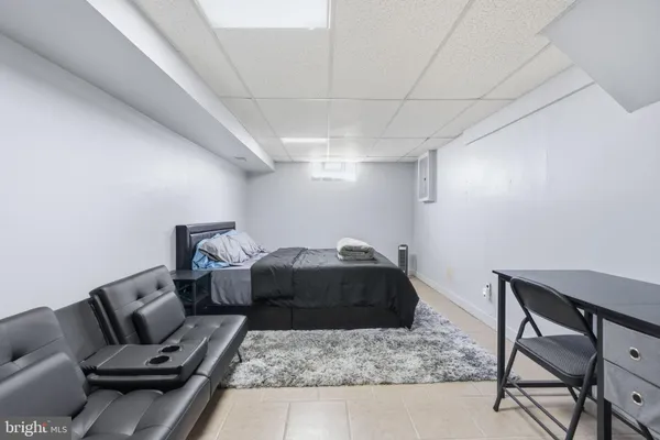 a bedroom with a bed and a large mirror