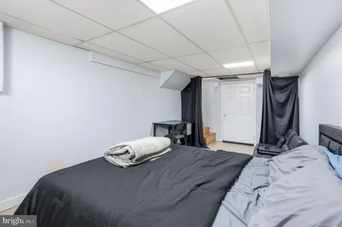 a bedroom with a bed and a large mirror