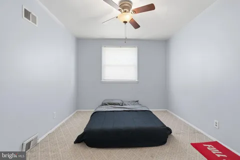 a bedroom with a bed and window