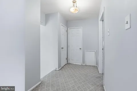 a view of a chandelier fan and hardwood floor