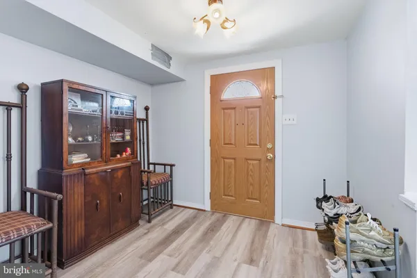 a living room with furniture floor to ceiling window and wooden floor