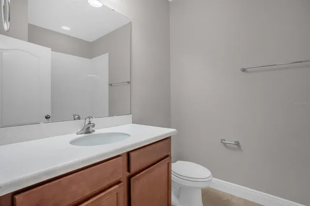 a bathroom with a sink toilet and a mirror