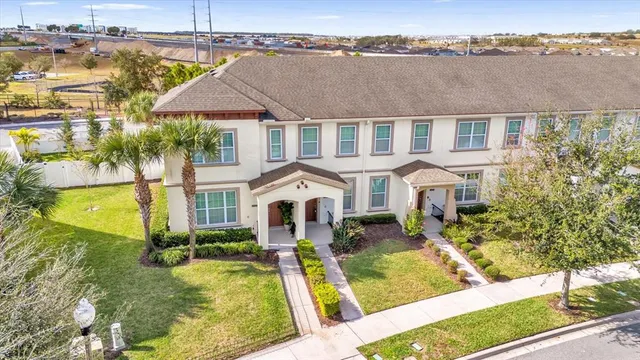 an aerial view of a house with a yard table and chairs