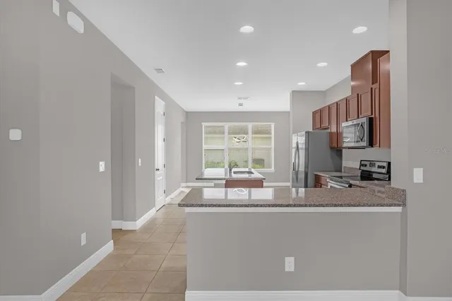 a living room with kitchen island furniture and a flat screen tv