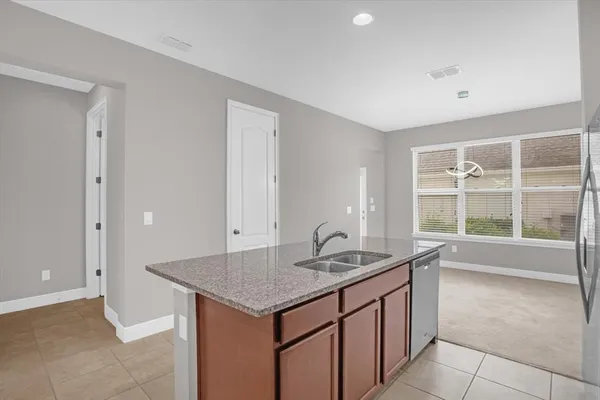 a kitchen with granite countertop a sink and a window
