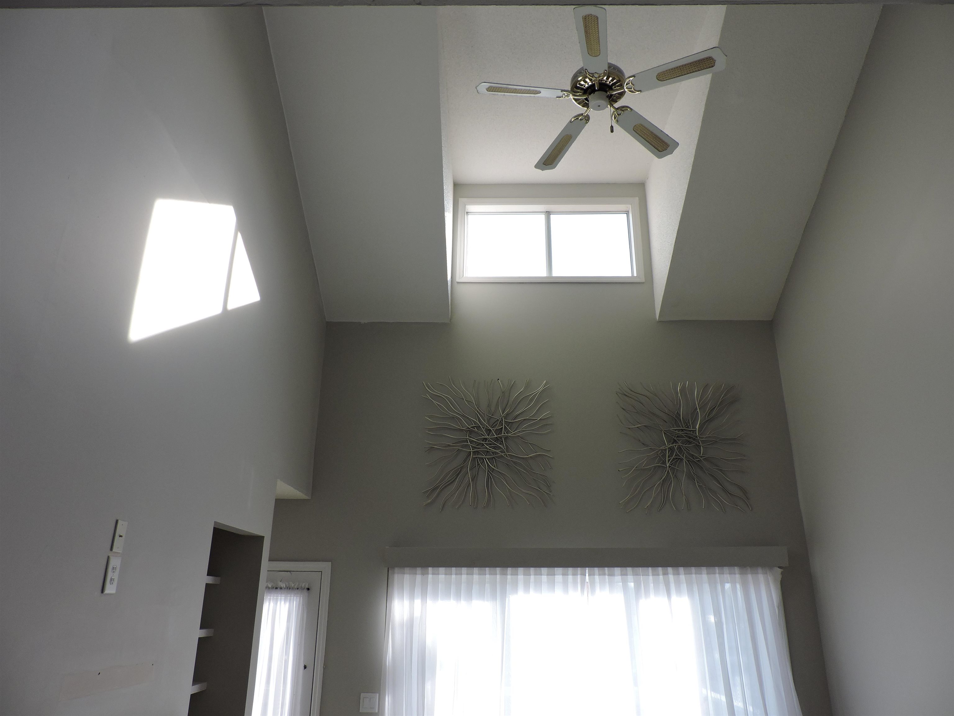 4396 Baldwin Avenue, Unit 80 Little River, SC 29566 - Photo 14 of 40 Unfurnished room with ceiling fan and a towering ceiling