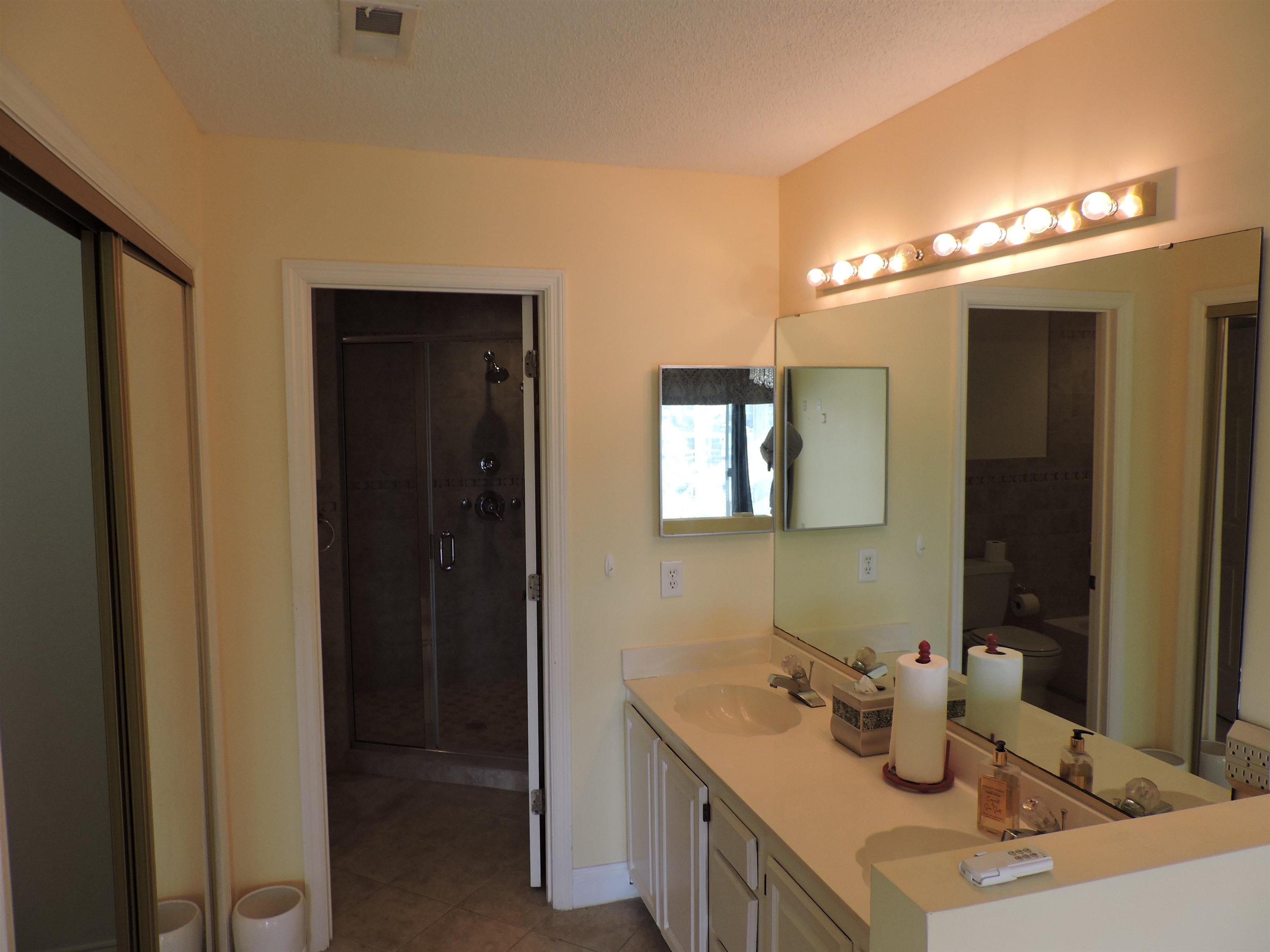 4396 Baldwin Avenue, Unit 80 Little River, SC 29566 - Photo 23 of 40 Full bath featuring double vanity, light tile patterned flooring, and a shower stall