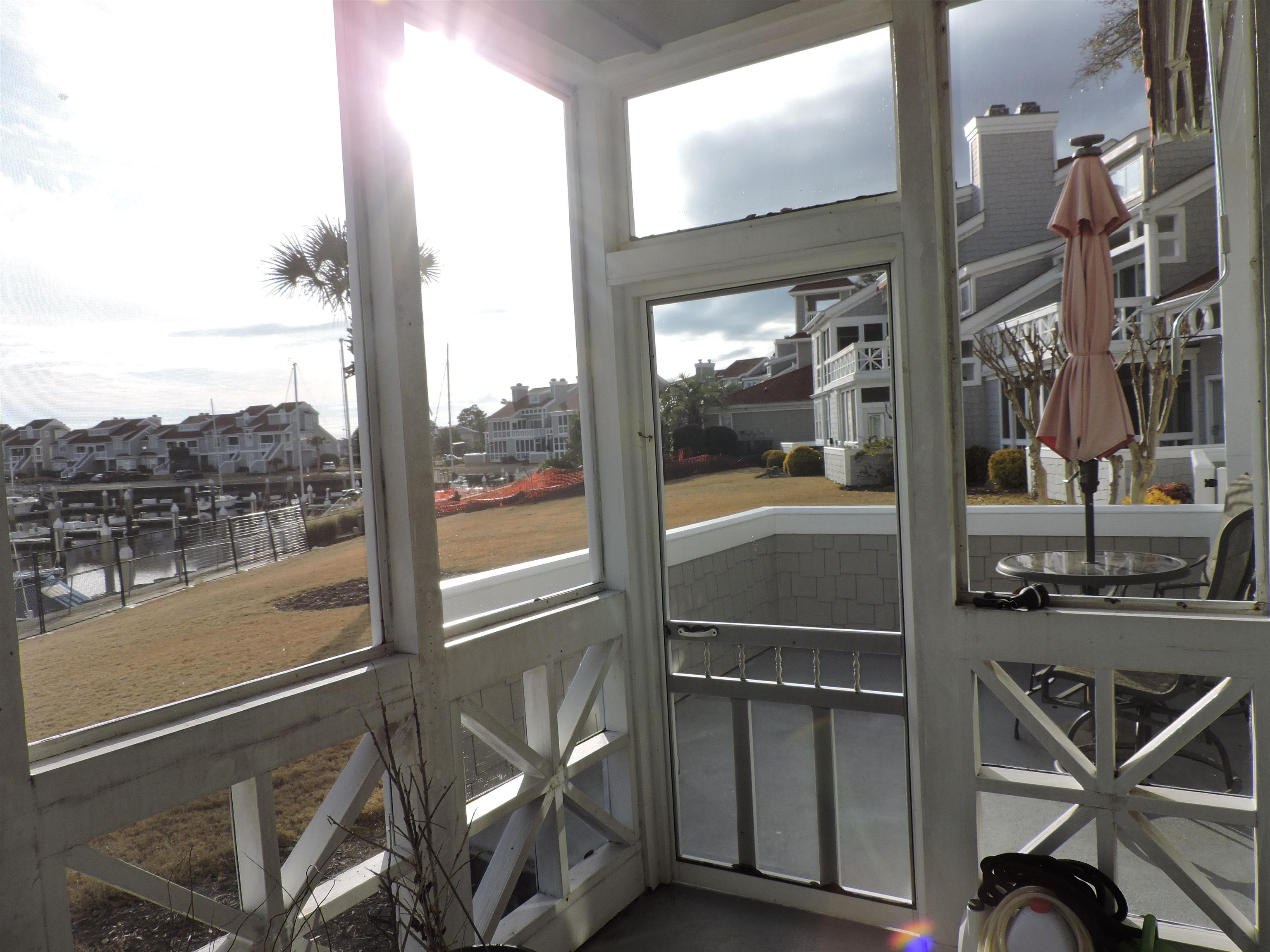 4396 Baldwin Avenue, Unit 80 Little River, SC 29566 - Photo 31 of 40 Sunroom / solarium featuring a residential view