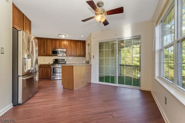a kitchen with stainless steel appliances a stove top oven and a refrigerator