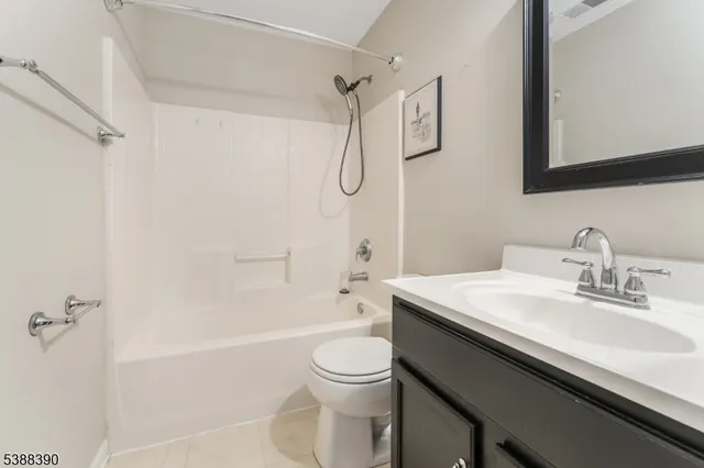 a bathroom with a granite countertop sink a toilet and shower