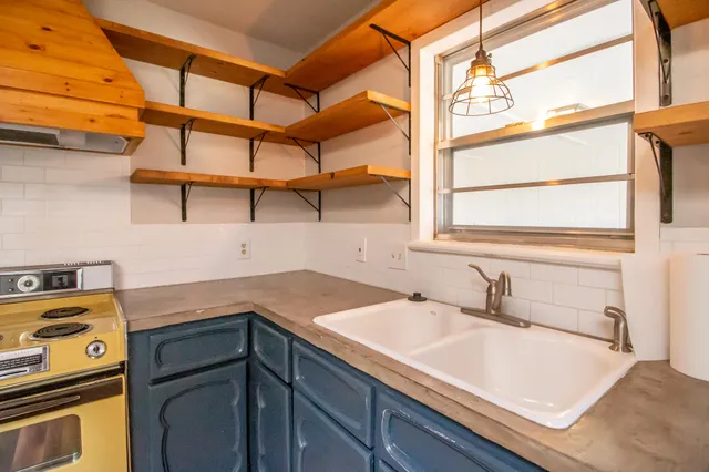 a utility room with a sink and a window